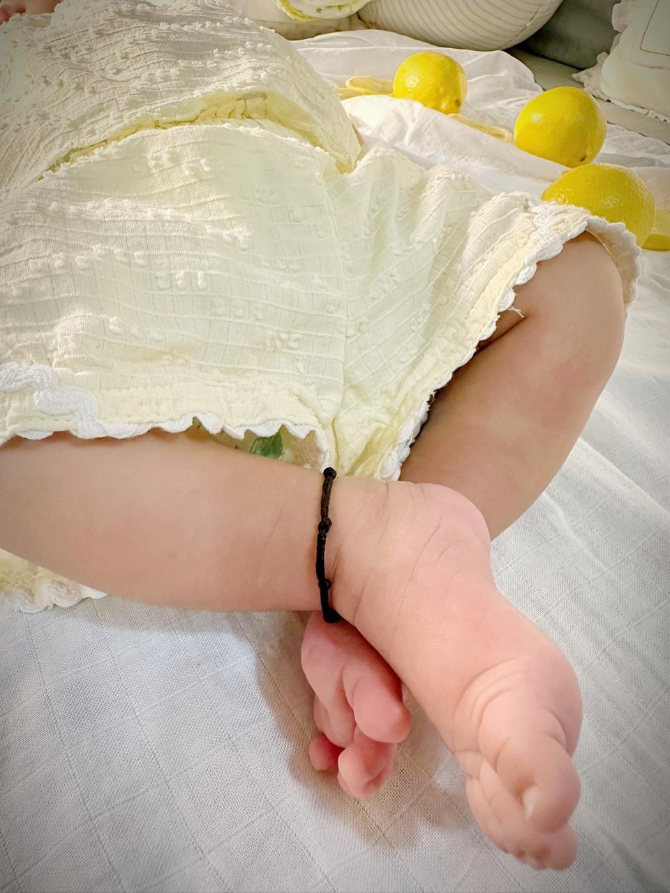 Tiny feet. Black thread anklet. Everything.